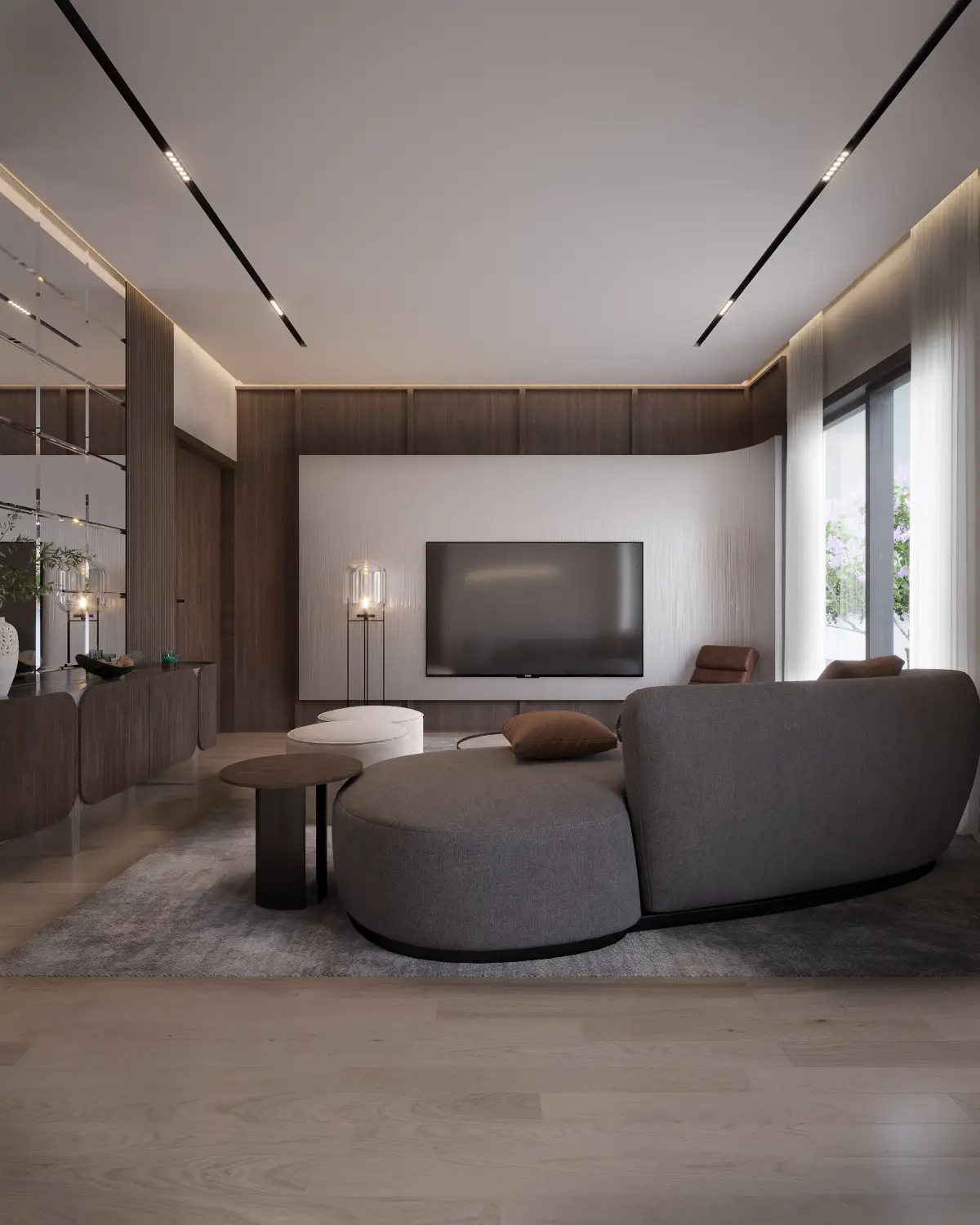 Balkasar Estate family room render. Curved grey sofa, walnut wall panelling, integrated TV, console with mirrored backdrop, Chakwal.