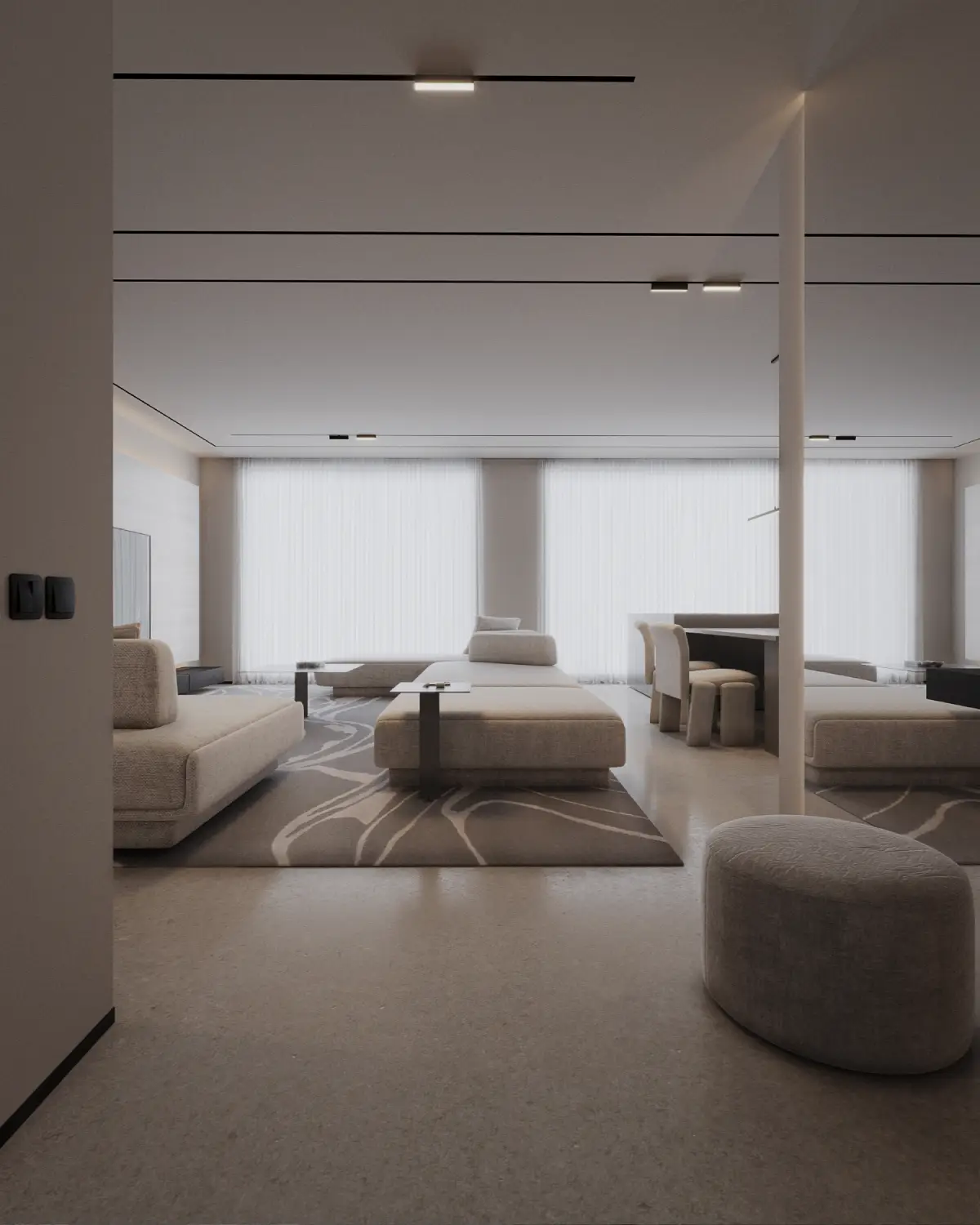 Casa Octavia living room with ottoman in foreground render. View through to dining beyond, polished travertine flooring with wave-patterned rug, residential interior, DHA Phase 6 Lahore.