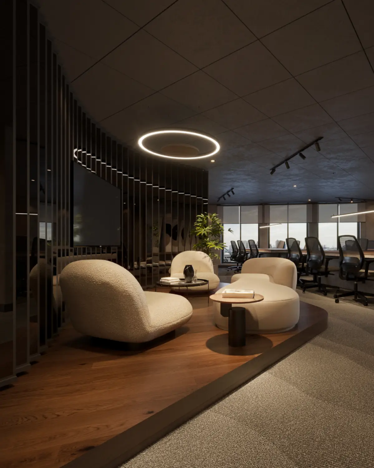 TopSpot Media lounge and breakout area render. Cream boucle lounge chairs, ring pendant overhead, slatted screen with TV, view through to open production floor with city skyline, corporate fitout, Lahore.